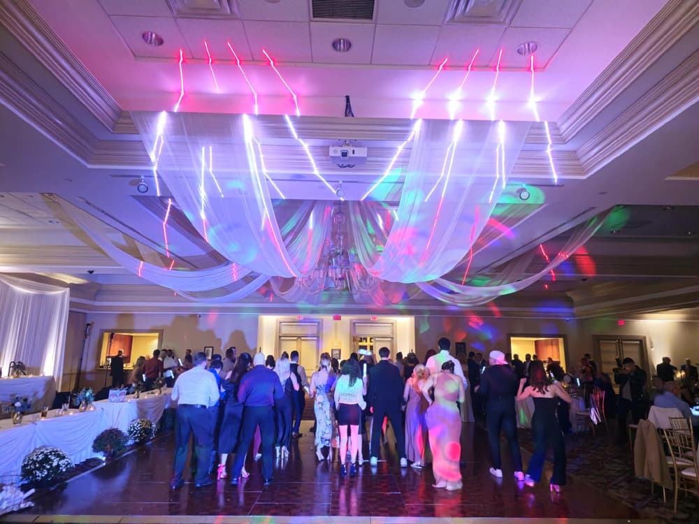 Wedding guests celebrating beneath professional event lighting — gallery photo 10