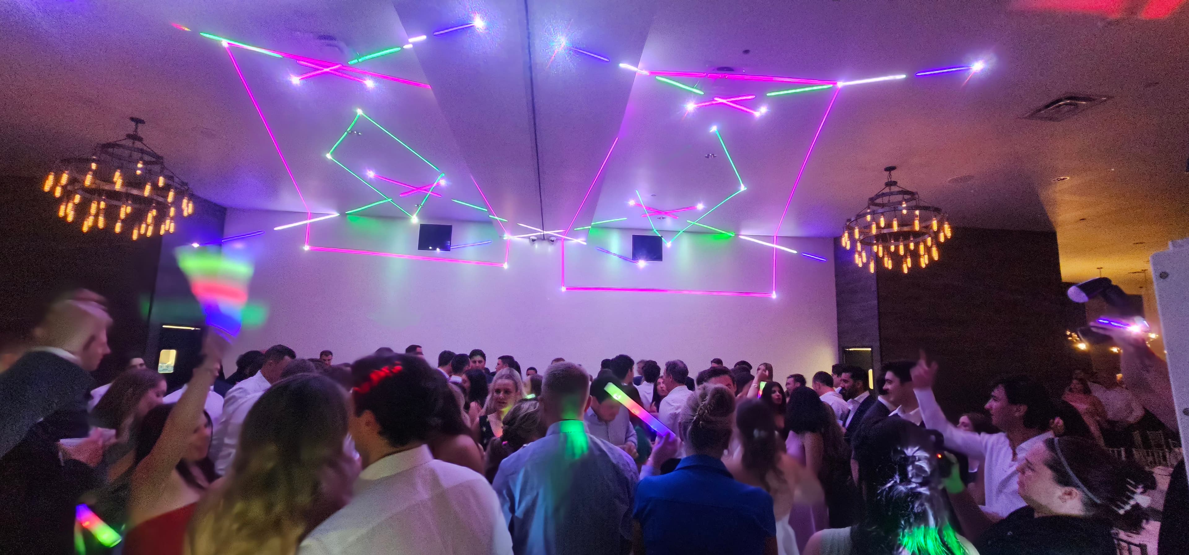 Wedding guests celebrating beneath professional event lighting — gallery photo 2